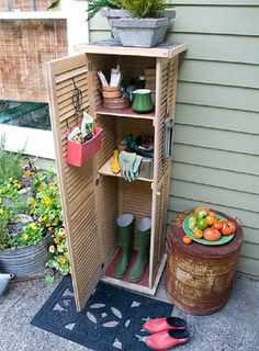 a potted plant sitting on top of a wooden shelf filled with gardening tools and vegetables