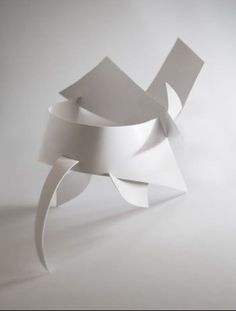 an abstract white sculpture is shown against a plain background with light coming from the top