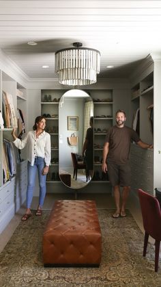 a man and woman are standing in the closet