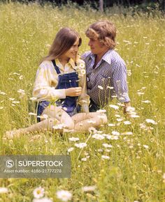 1970s Romantic Teenage Couple Sitting In A Field Of Daisies Sitting In Flower Field Reference, Couple Sitting Together Reference, Couple Sitting Together Pose Reference, Couple Sitting Reference, Couple Sitting Poses Reference, Two People Sitting Together Reference, Sitting In A Flower Field, 1970s Couple, Sitting Couple Poses