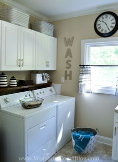 a washer and dryer sitting in a kitchen next to a window with the word wash on it