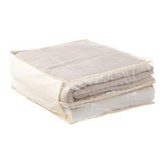 a white and beige blanket folded on top of each other with two zippered pockets