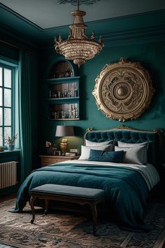 a bedroom with teal walls, gold accents and a chandelier above the bed