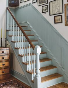 a staircase with pictures on the wall next to it