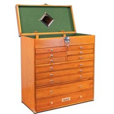 a wooden chest with many drawers and a green cover on it's top shelf