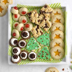 a tray filled with cookies and pastries on top of a table