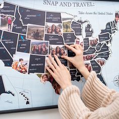 a woman placing pictures on the map of the united states in front of her hands