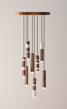 a chandelier made out of wood and white tubes hanging from it's ceiling