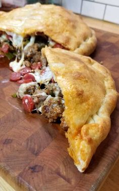 two pieces of meat pie on a cutting board