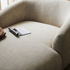 a magazine is laying on the corner of a couch