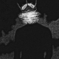 a man standing in the dark with his back to the camera