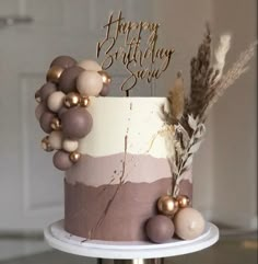 a birthday cake decorated with pink and gold decorations