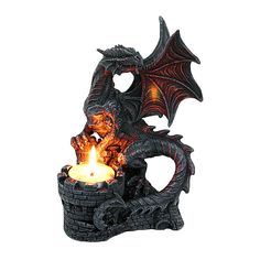 a dragon statue with a lit candle in it's mouth, on a white background