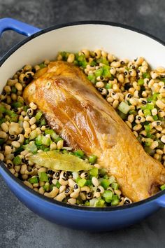 a fish and some vegetables in a blue pot