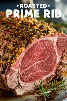 roasted prime rib on a plate with rosemary garnish and seasoning sprigs