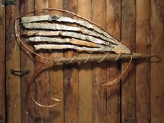 a wooden wall hanging with rope and wood planks in the shape of an american flag