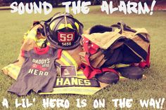 a fireman's gear and helmet sitting on the grass