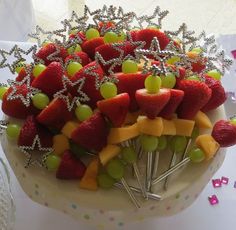 a cake decorated with fruit and silver decorations