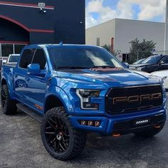 a blue truck parked in front of a building