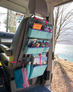 the back seat of a car with several items hanging on it's side rack