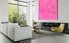 a living room filled with furniture and a large painting hanging on the wall above it