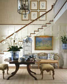 a dining room table with chairs under a stair case