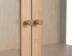 a wooden door with two knobs on the front and back doors are shown in this close up photo