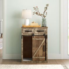 a wooden table with a lamp on top of it next to a door and window