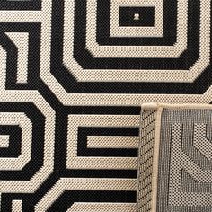 an area rug with black and white designs on it