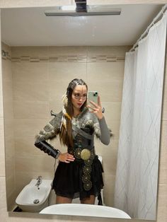 a woman taking a selfie in a bathroom mirror