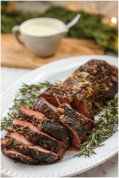 roast beef with herbs and seasoning on a white plate