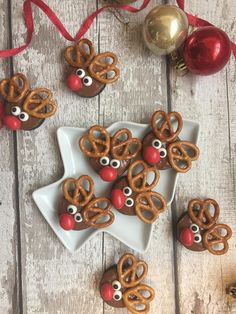 some pretzels are decorated like reindeers and rudolph's nose is on the plate