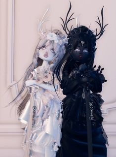 two dolls dressed in black and white are standing next to each other with long hair