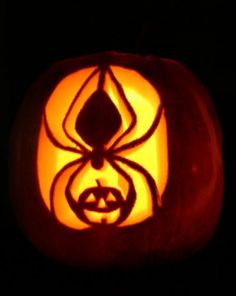 a carved pumpkin with a spider on it