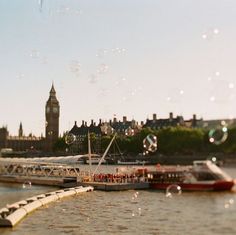 there is a boat that is going down the river and it looks like bubbles are floating in the air