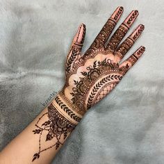 a henna tattoo on the palm of someone's hand