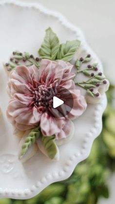 a white plate topped with flowers and leaves