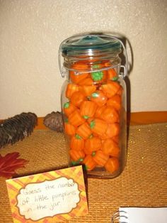 a jar filled with candy sitting on top of a table next to a notepad