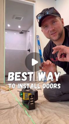 a man is sitting on the floor with an electric toothbrush in his hand and pointing at it