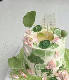 a cake decorated with flowers and leaves on a plate