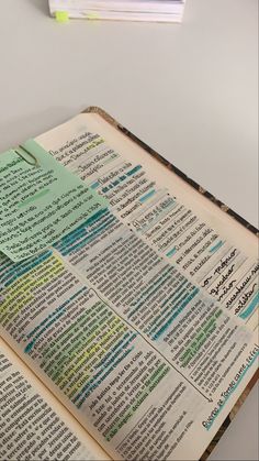 an open bible on a white table