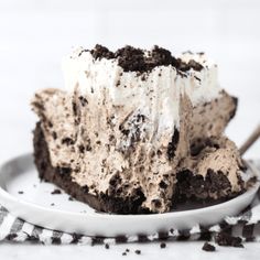 a piece of ice cream cake on a white plate with a fork in the middle