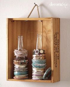 a wooden box filled with lots of different types of bracelets on top of each other