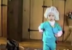 a little boy in scrubs and a white hat