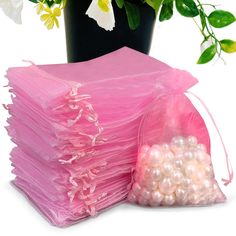 a bunch of pink tissue sitting next to a potted plant