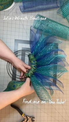 someone is working on something with blue and green feathers