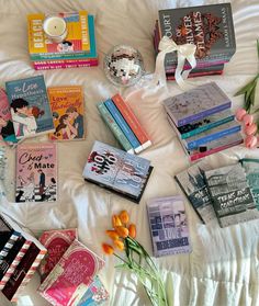 a bed topped with lots of books on top of it