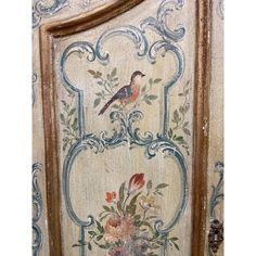 an ornate painted door with flowers and birds on it