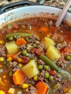 a white bowl filled with soup and vegetables