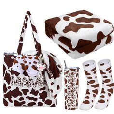 a brown and white cow print purse, booties, blanket, and handbag